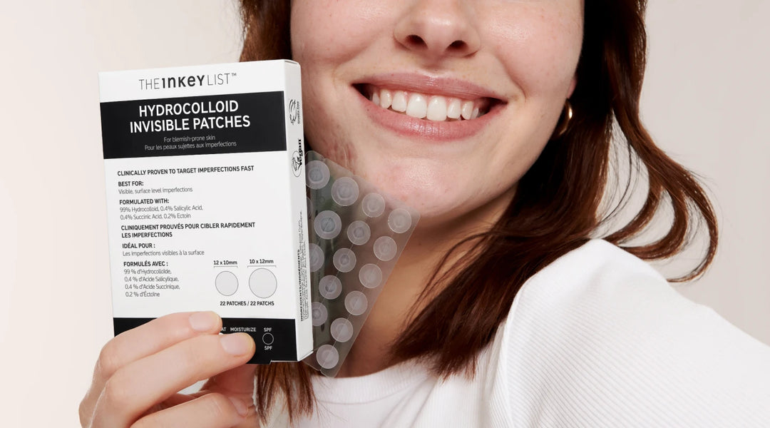 Model holding a pack of Hydrocolloid Invisible Patches