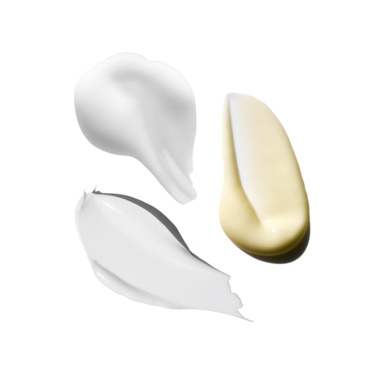 Three swatches of cream in white, beige, and gray on a white background