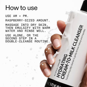 Hand holding aMilk Cleanser with usage instructions on a white background
