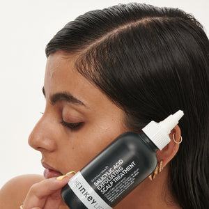 Clean & Healthy Scalp Duo model holding Salicylic Acid Scalp Treatment