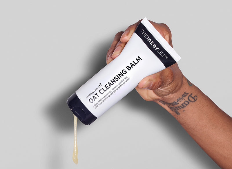 Model squeezing Oat Cleansing Balm bottle