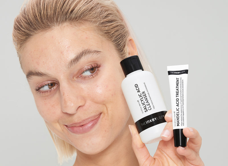 Model holding Salicylic and Succinic Acid bottles