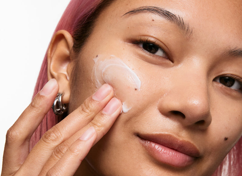 Model applying skincare blog cover