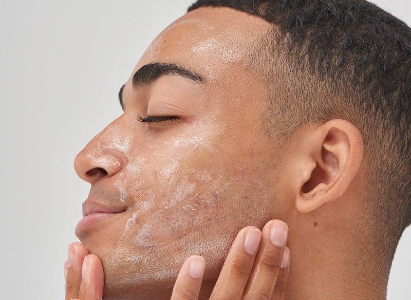 Male model applying skincare