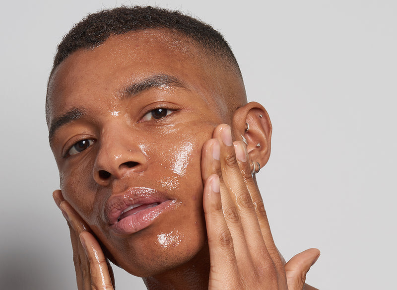 model rubbing product into his face