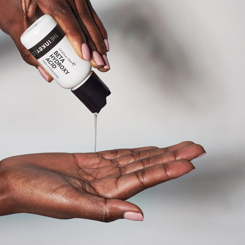 Model pouring Beta Hydroxy Acid Serum on hand
