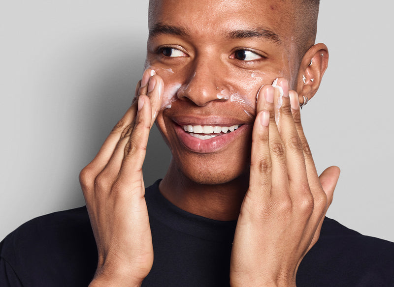 Male model applying skincare 