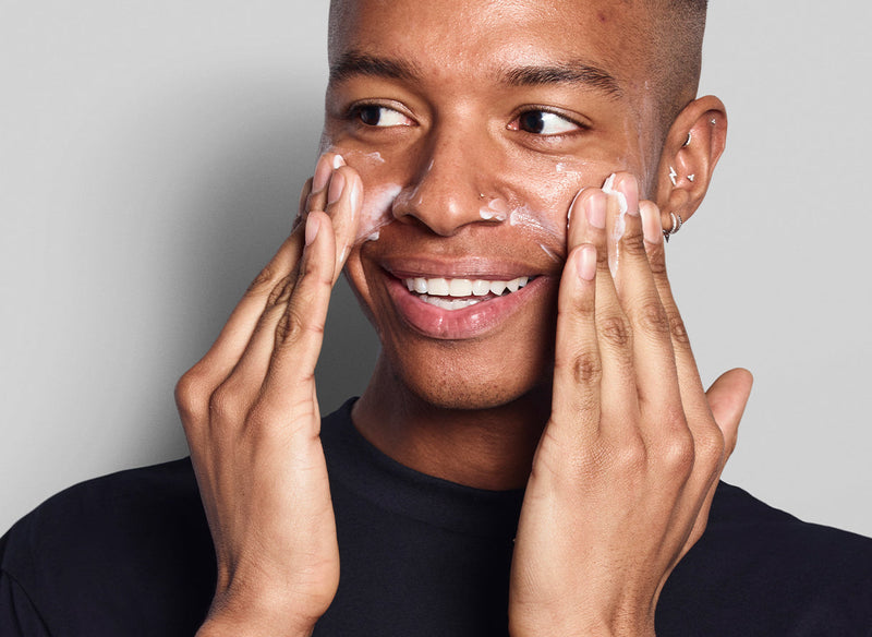 Male model applying skincare 