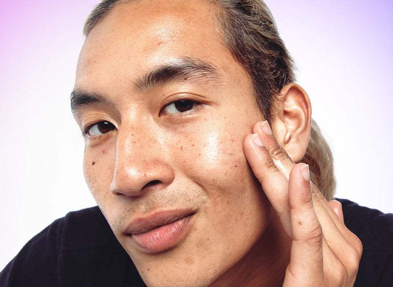 Model rubbing product into his forehead