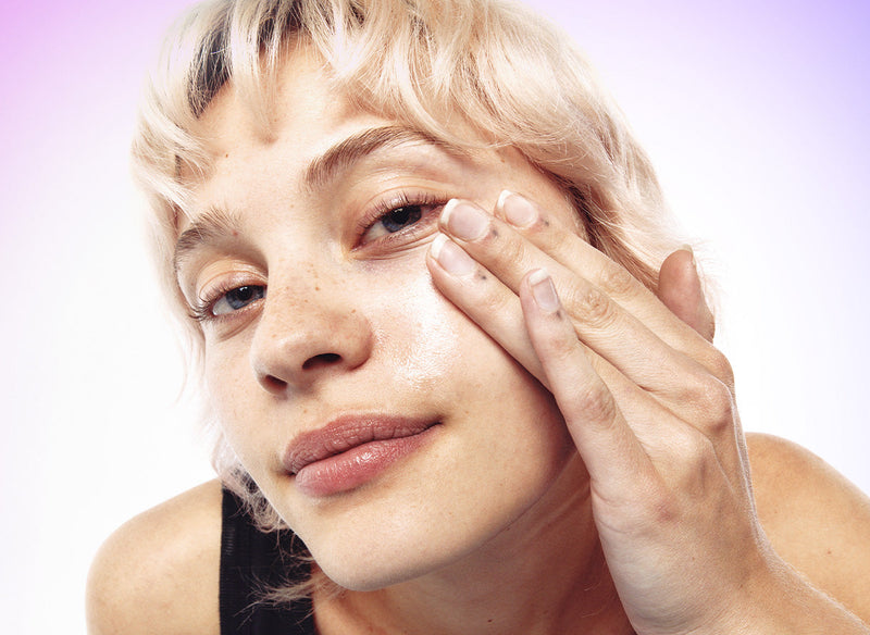 Blonde model with hand on her face