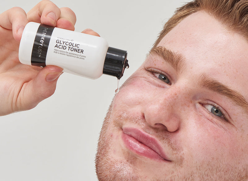 Male model applying Glycolic Acid Serum