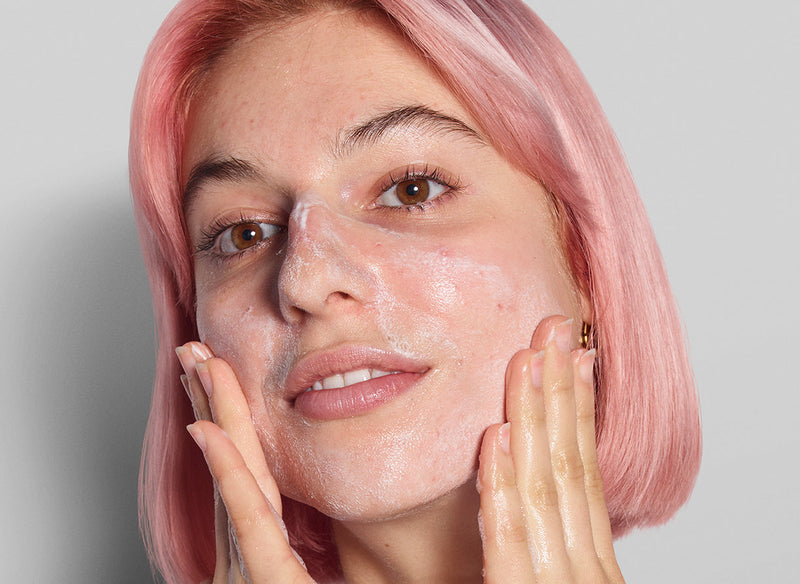 Model with pink hair applying The INKEY List