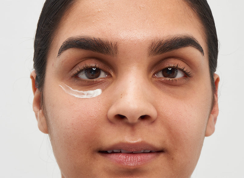 Model with eye cream under her eye