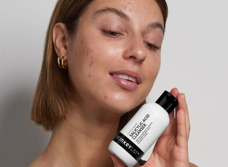 Model holding Salicylic Acid Cleanser