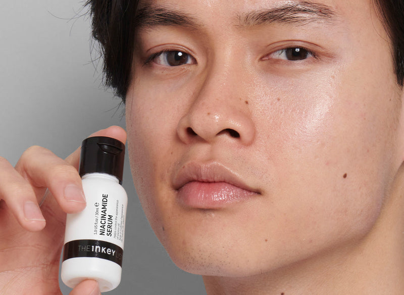 Model holding The INKEY List skincare