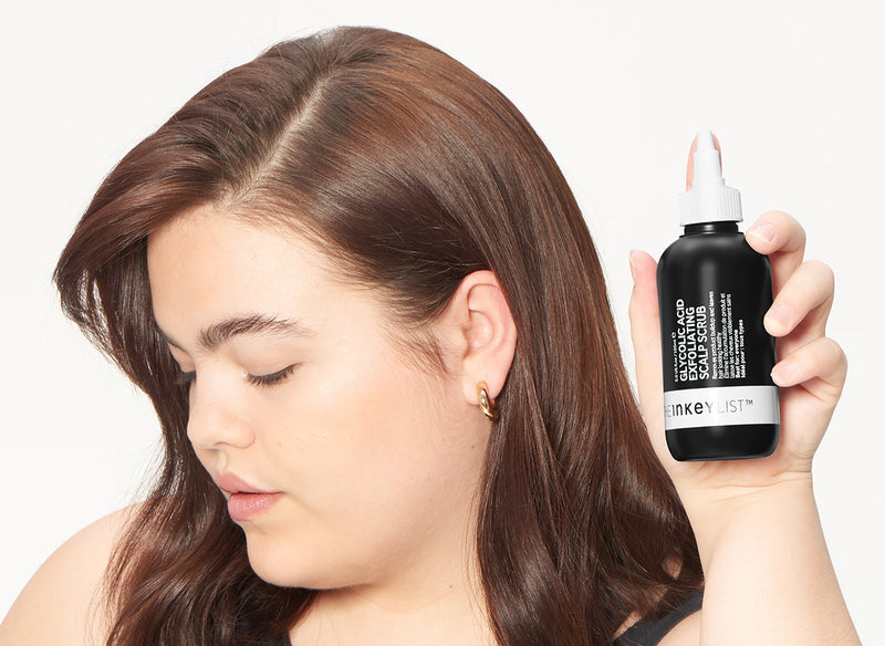 Model holding Glycolic Scalp Scrub 