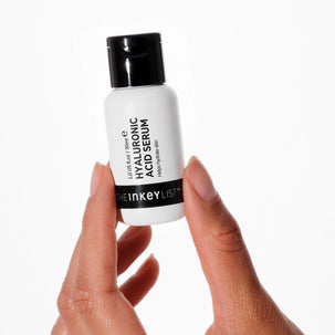 Model holding hyaluronic acid serum 