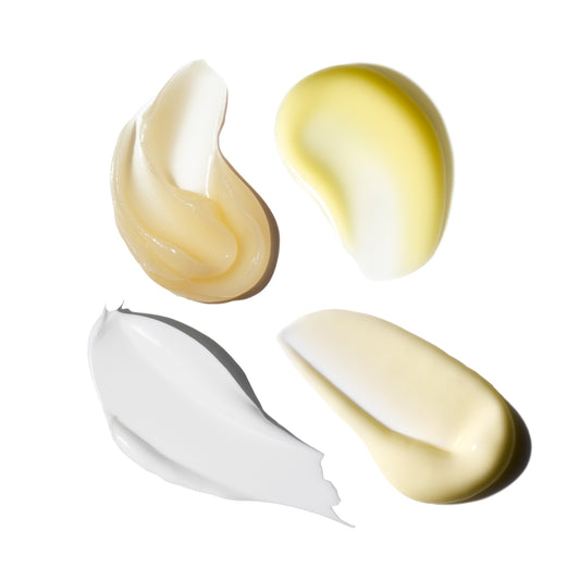 Three swatches of different colored creams on a white background