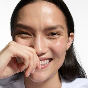 Close-up of a person with a neutral expression on a white background