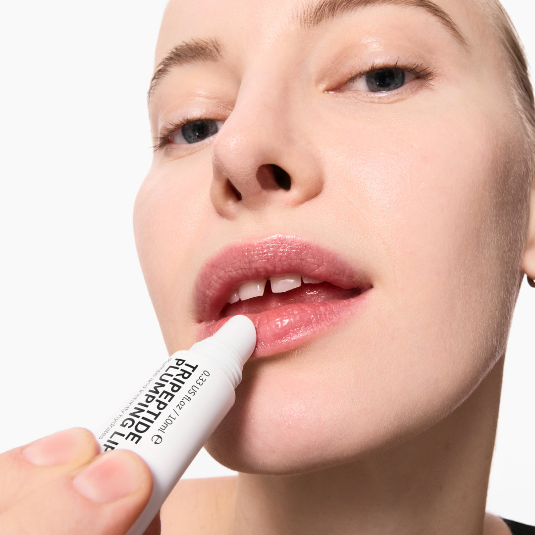 Model applying Tripeptide Plumping Lip Balm