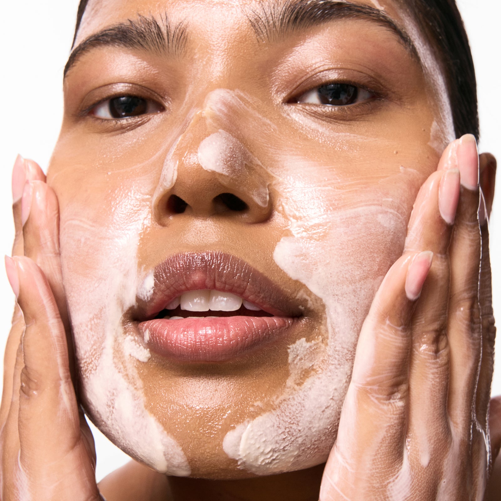 Model washing her face with Oat Cleansing Balm