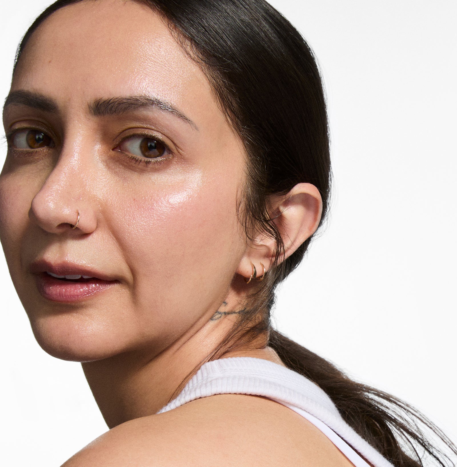 Close-up of a woman with a neutral expression on a white background