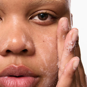 Model washing their face with Salicylic Acid Cleanser