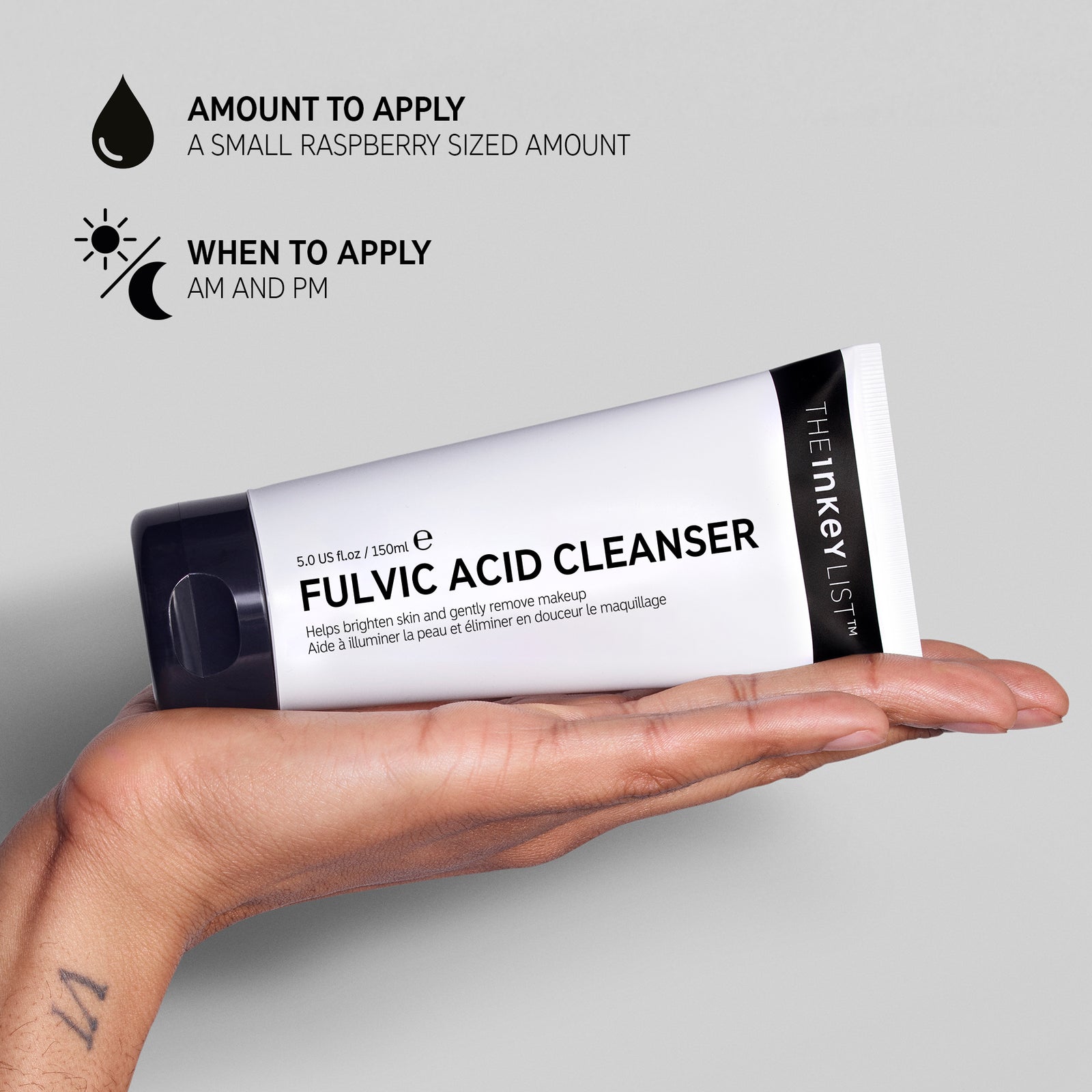 Hand holding Fulvic Acid Cleanser with text explaining amount to apply (small raspberry sized amount) and when to use it in your routine (AM and PM)