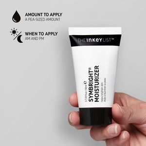 Hand holding Symbright Moisturizer on grey background with black text explaining amount to apply (grape-sized amount) and when to use it (AM and PM)