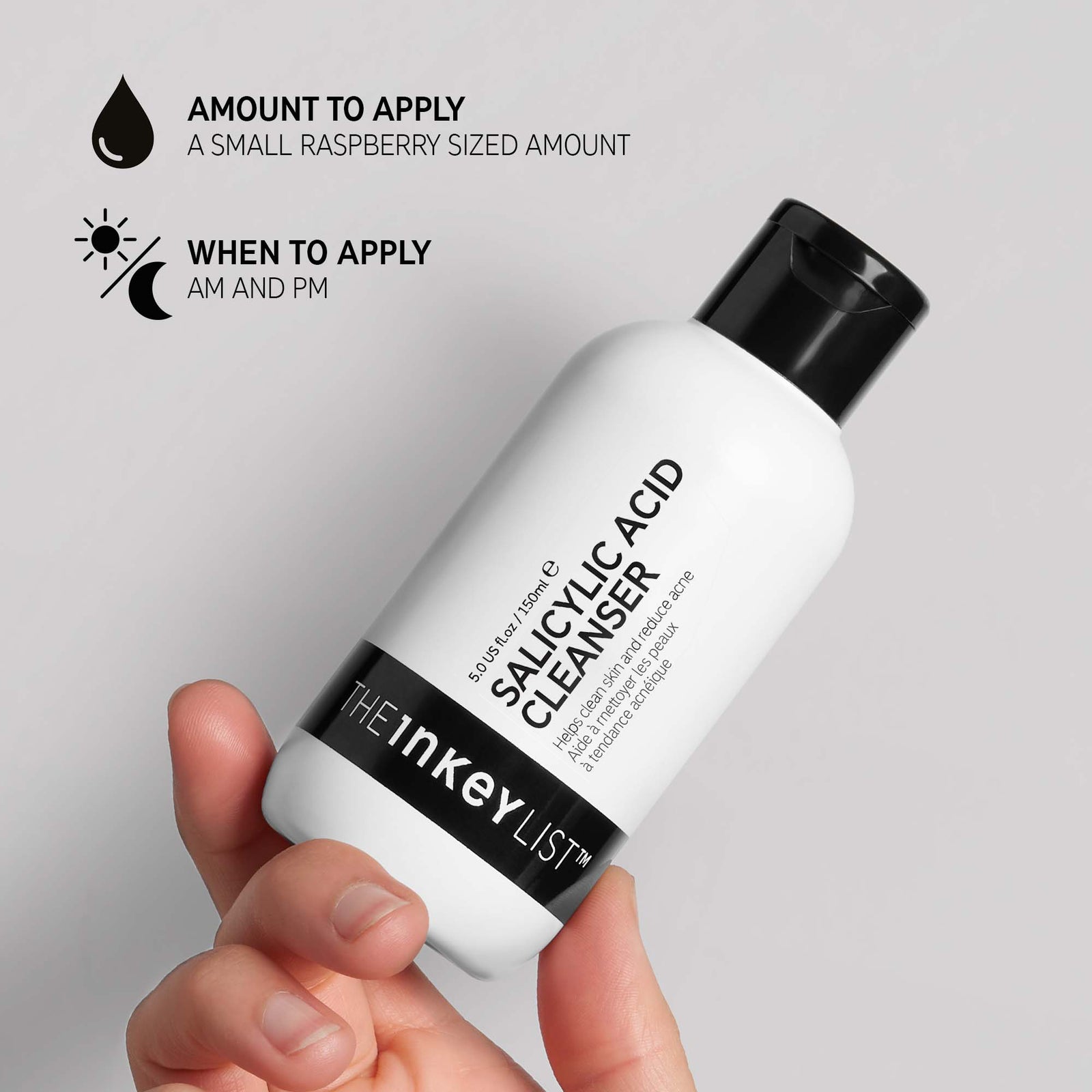 Hand holding Salicylic Acid Cleanser bottle with black text explaining how and when to use it. The text reads 'Amount to apply (small raspberry sized amount)' and 'When to apply (AM and PM)'